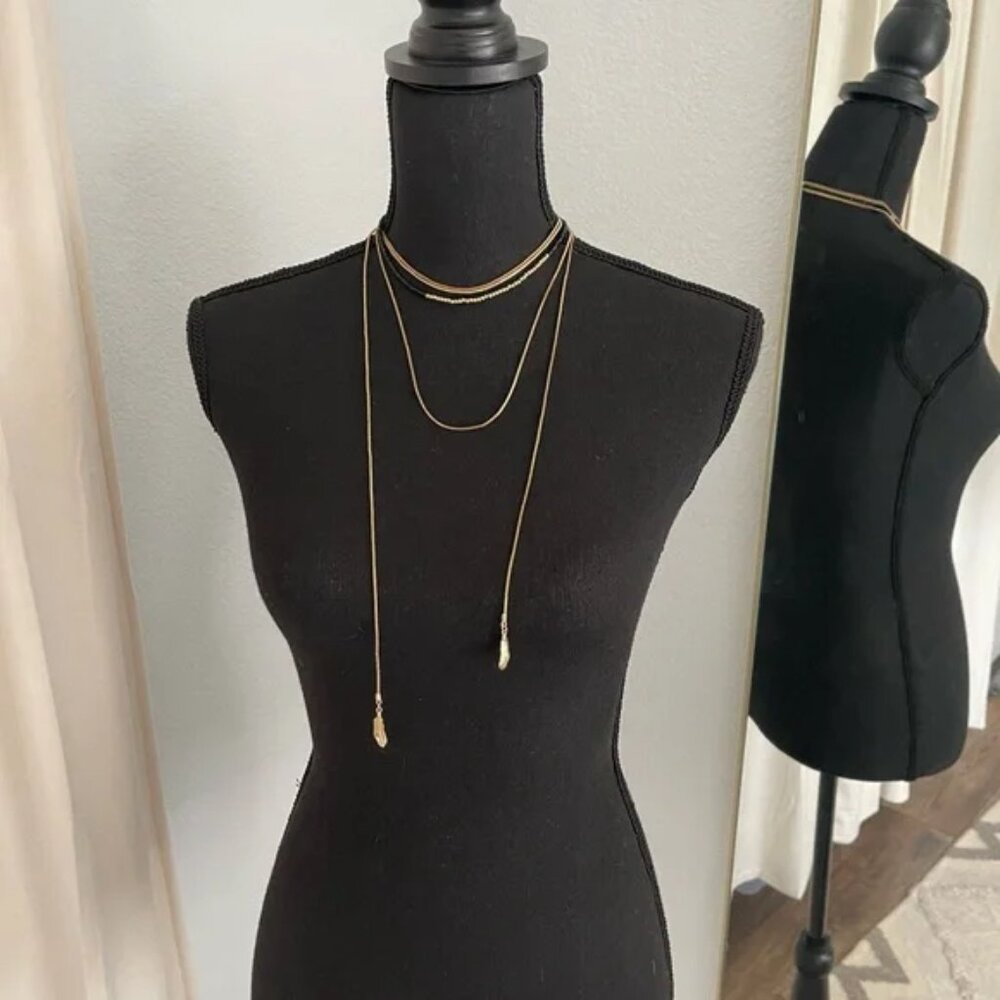 Black and gold bead box chain, draping necklace with gold feather detail.